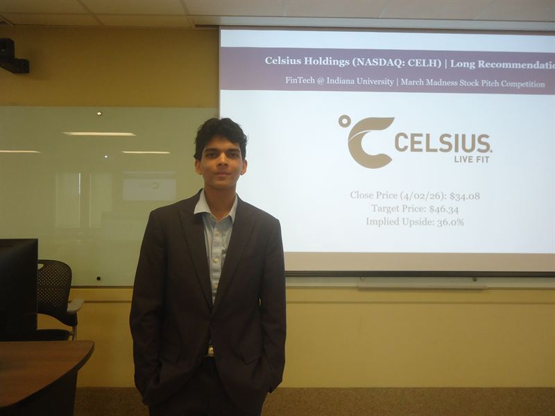 Member in a suit beside a Celsius Holdings long recommendation slide